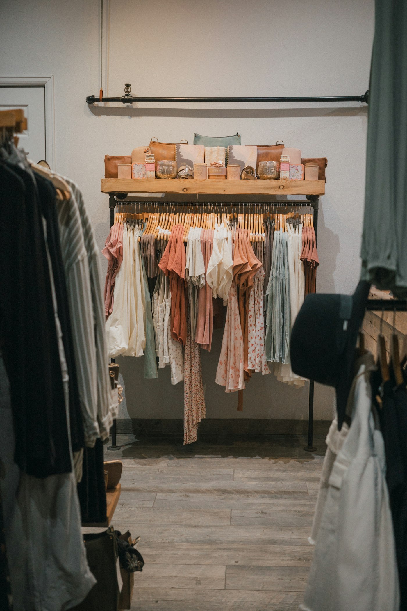 Racks of colorful women's clothing displayed in a bright boutique